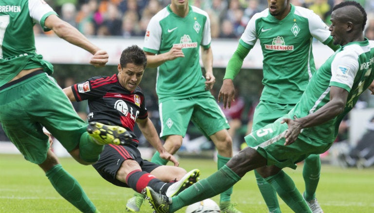 Chicharito, entre varios jugadores del Werder Bremen