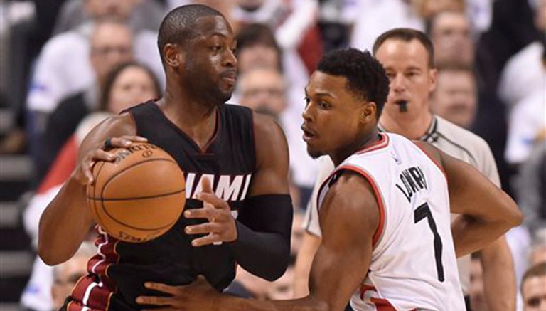 Dwyane Wade controla el balón frente a Kyle Lowry, de los Raptors