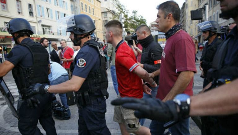 Policías deteniendo a Hooligans 