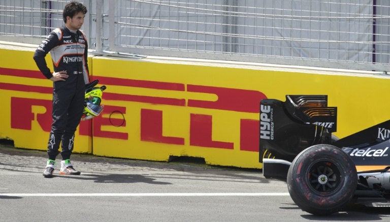 Checo Pérez observa su auto sobre el cicuito