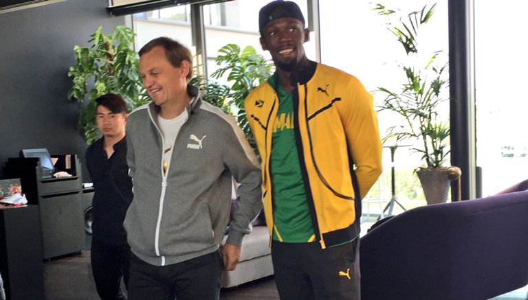 Usain Bolt junto a Bjorn Gulden, CEO de Puma