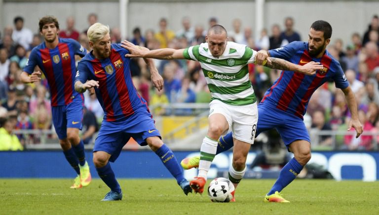 Scott Brown pelea un balón con Messi y  Turan en el duelo entre Celtic y Barça 