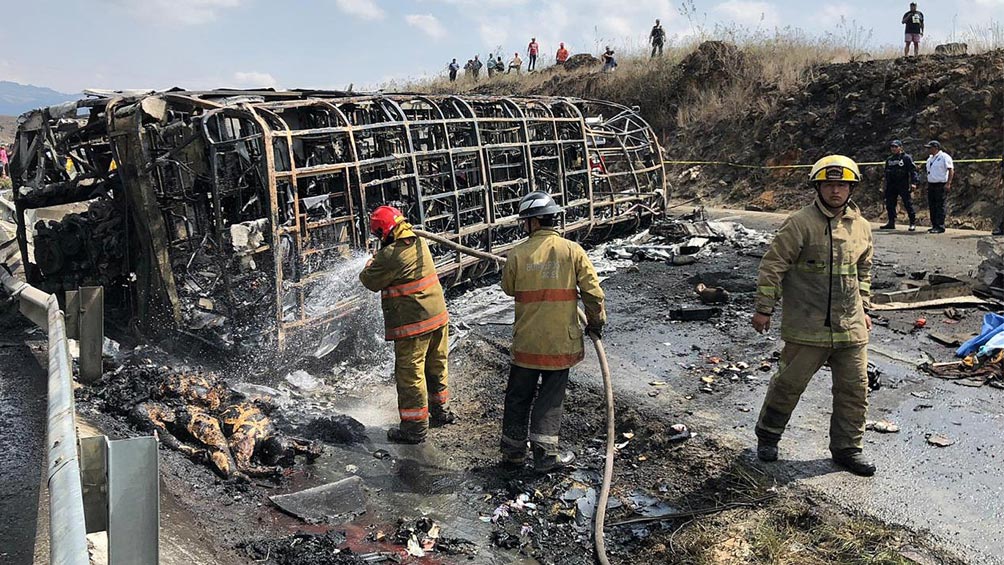 Bomberos controlan el fuego tras el choque entre autobús y trailer