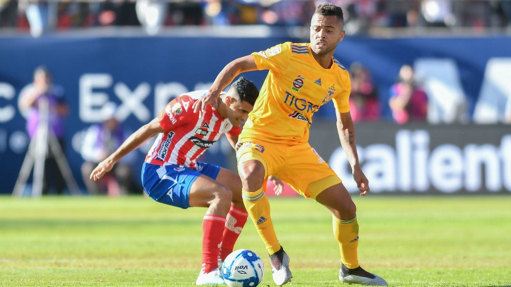 Jugadores del Atlético de San Luis y Tigres disputan un balón