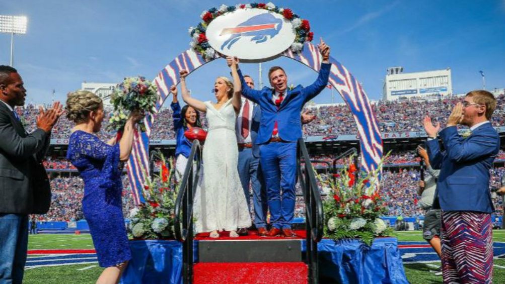 Pareja de novios festeja tras casarse en el New Era Field 