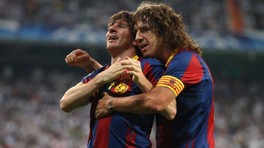 Messi y Puyol durante un partido con Barcelona