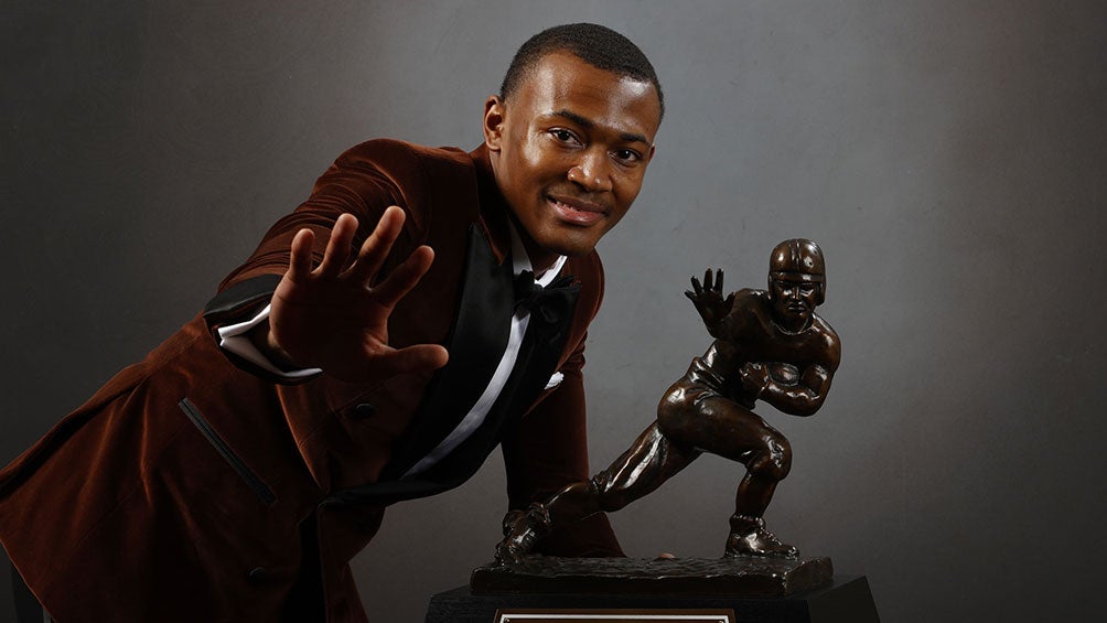 DeVonta Smith posa junto al Trofeo Heisman  