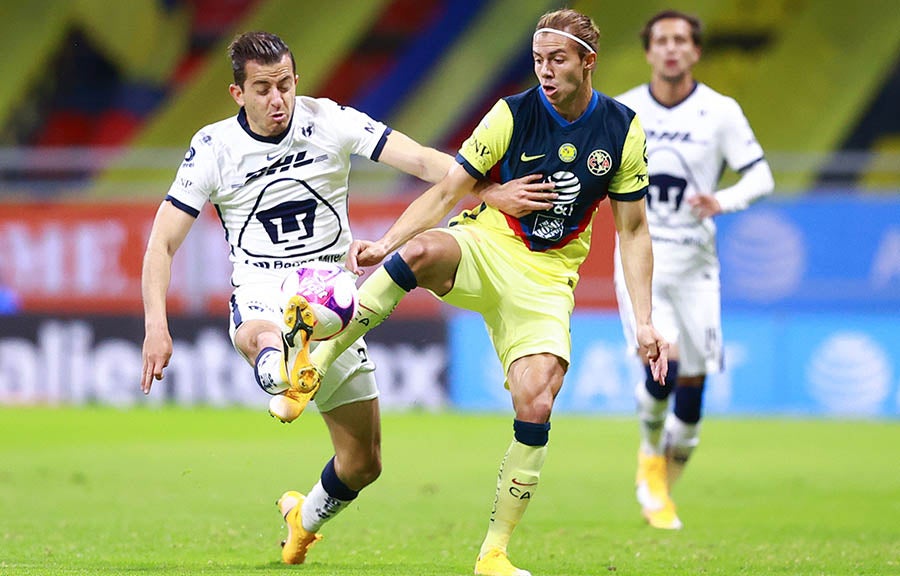 Sebastián Córdova pelea el balón con Alan Mozo en un América vs Pumas