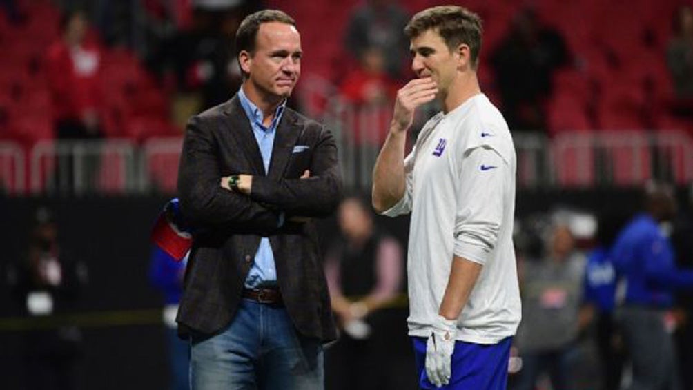 Peyton y Eli Manning en un campo de futbol americano 