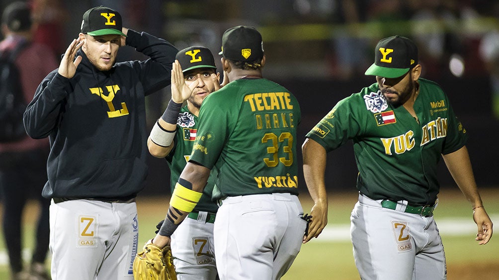 Jugadores de Leones de Yucatán celebran tras una carrera 