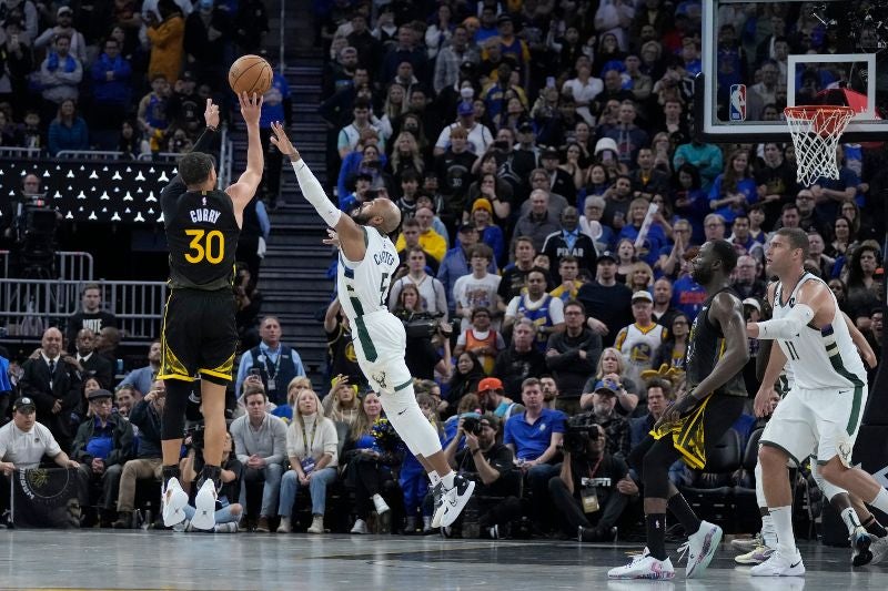 Stephen Curry, encesta un triple contra Jevon Carter