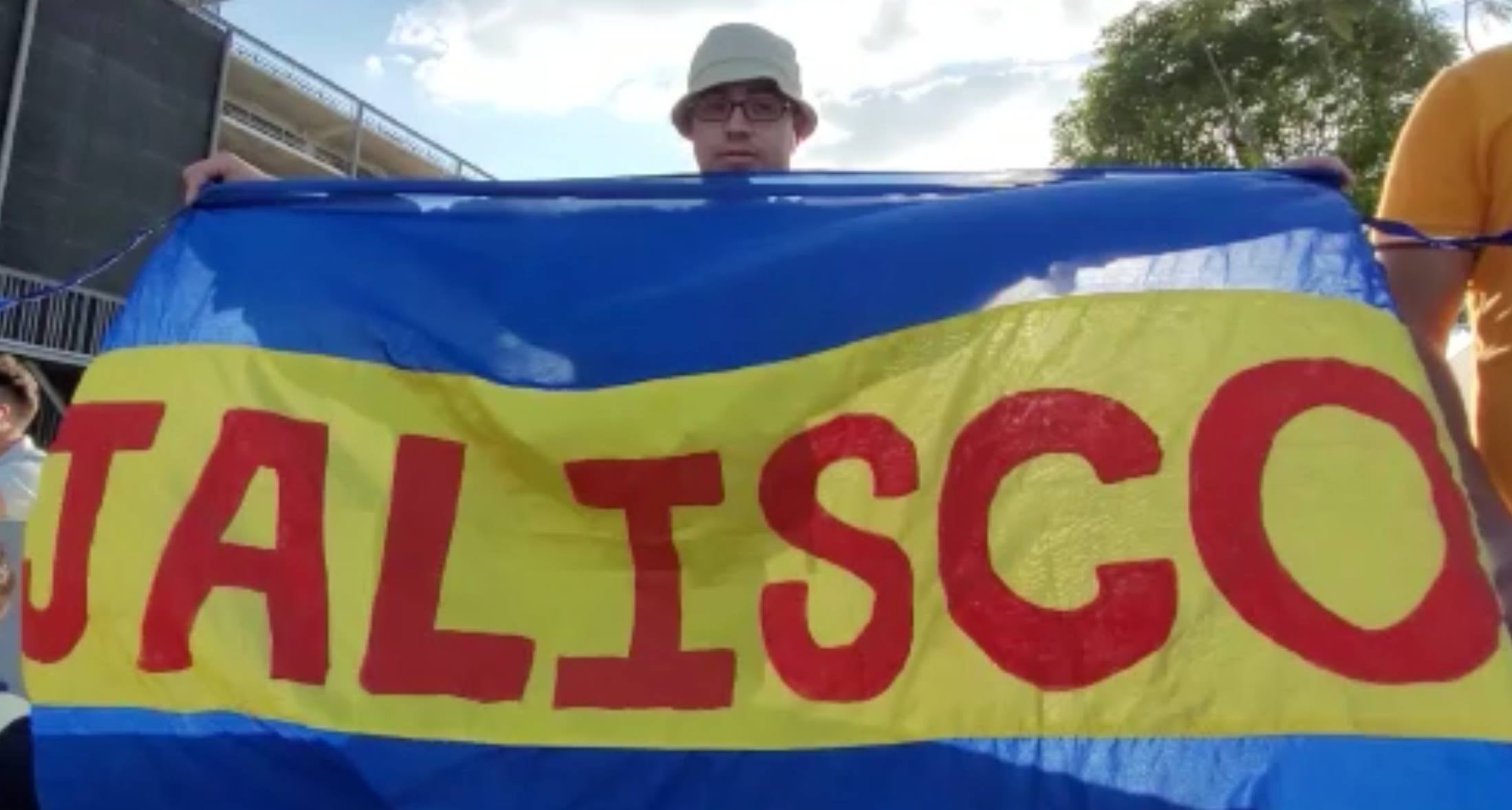 Aficionado posa con bandera durante el entrenamiento