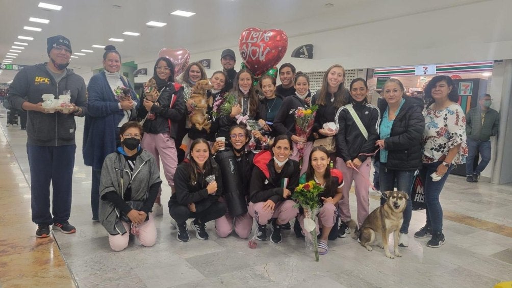 Las nadadoras se toman una foto en el aeropuerto