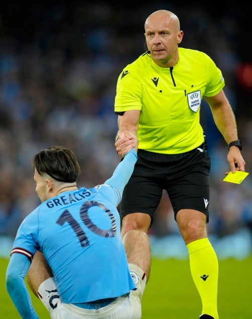 Marciniak levantando a Jack Grealish