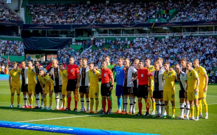 Jugadores de Alemania y Ucrania posan para una fotografía