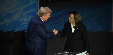 Donald Trump y Kamala Harris en debate presidencial estrechándose la mano