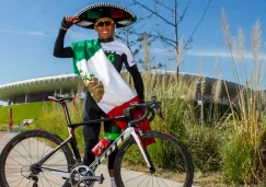 Irving Pérez posa junto con su bicicleta a las afueras del Estadio Chivas