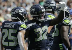 Chris Carson celebra un tochdown ante Cincinnati