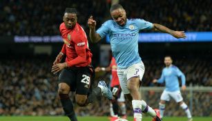 Jugadores del Manchester City y Manchester United disputan la bola