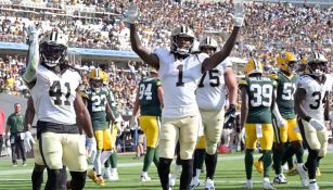 Jugadores de los Saints celebran ante los Packers