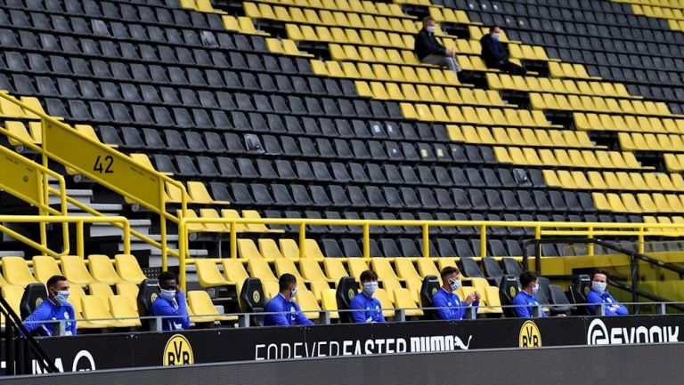 Jugadores del Borussia guardan distancia en la banca